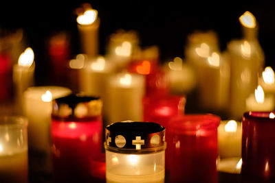 Close-up of lit candle in dark room
