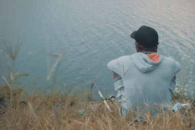 Rear view of man sitting on land