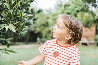 Portrait of girl looking at plants