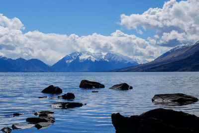 Scenic view of sea and mountains against sky