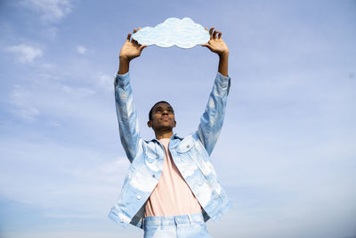 Low angle view of man standing against sky