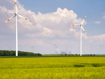 Windmill on field against sky