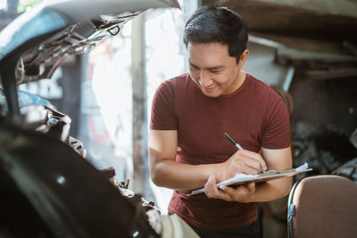 Side view of man using mobile phone