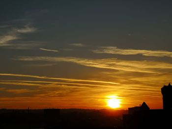 Low angle view of silhouette buildings against sky during sunset