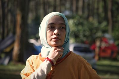 Portrait of young woman in park