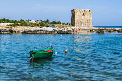 Boat moored in sea against sky