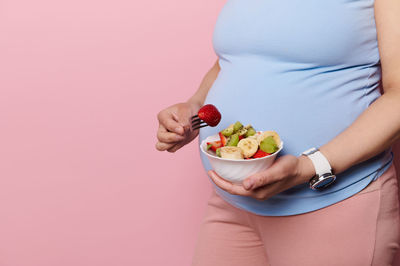 Midsection of woman holding food