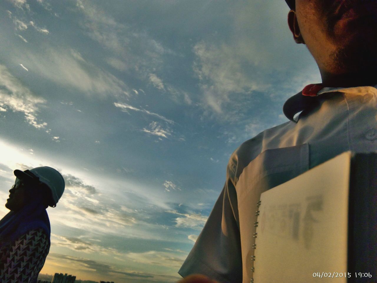 sky, cloud - sky, building exterior, cloud, built structure, men, architecture, cloudy, low angle view, lifestyles, part of, leisure activity, cropped, silhouette, person, outdoors, sunset, day