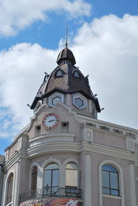 Low angle view of building against cloudy sky