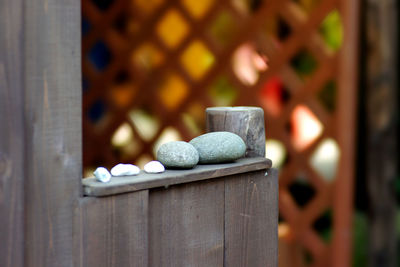 Close-up of stone stack on wooden window