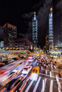 Light trails on road in city at night