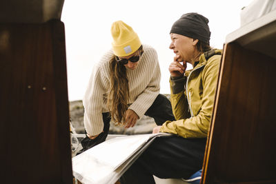 Women looking at map on boat