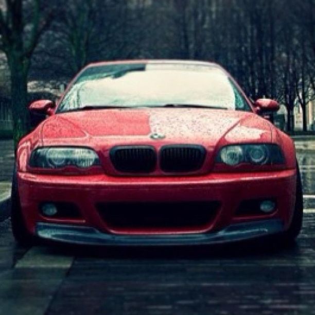 transportation, red, mode of transport, land vehicle, car, focus on foreground, tree, selective focus, close-up, travel, day, part of, outdoors, stationary, old-fashioned, reflection, street, on the move, no people, road