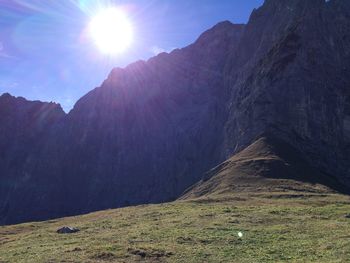 Scenic view of mountains against sky on sunny day