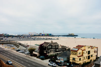 Houses at beach against sky