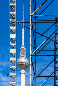 Low angle view of communications tower against sky