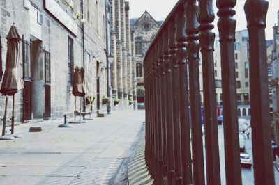 Footpath amidst buildings in city