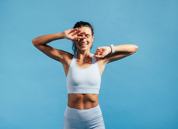 Smiling woman against blue background