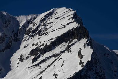 Scenic view of snowcapped mountains against clear blue sky