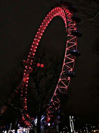 Low angle view of illuminated ferris wheel at night