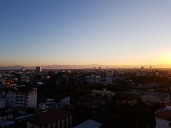 High angle view of buildings against sky during sunset