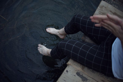 Low section of man relaxing on water