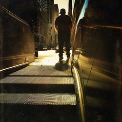 Rear view of man walking on steps