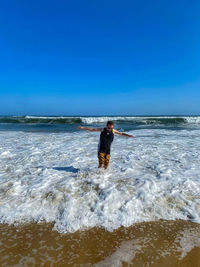 Man surfing in sea against clear sky