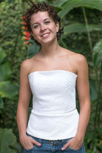 Portrait of smiling teenage girl standing outdoors