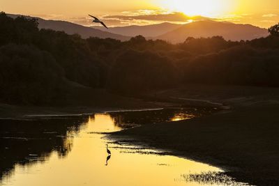 Scenic view of lake against sky during sunset