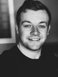 Portrait of smiling young man at home