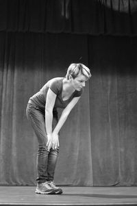 Side view of young woman standing on the scene