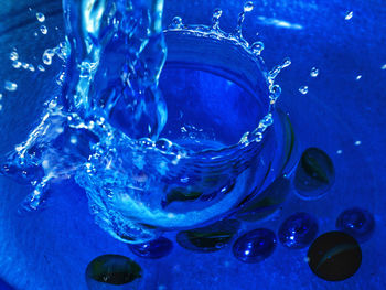 Close-up of water drop on blue sea