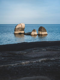 Scenic view of rocky sea shore against sky. selective focus. lamai beach, koh samui, thailand.