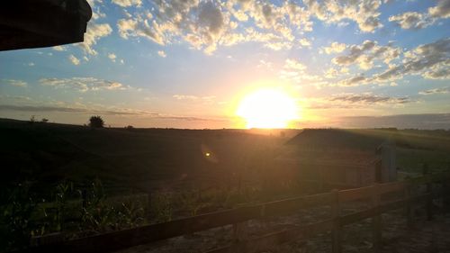 Scenic view of field against sky during sunset