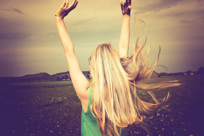 Rear view of woman in field