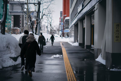 Rear view of woman walking on street