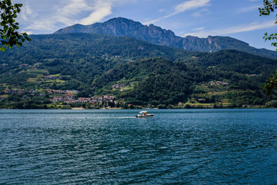 Scenic view of sea and mountains against sky