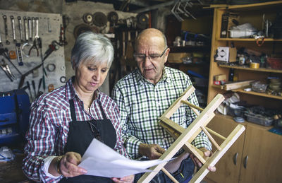 Man and woman sitting on table