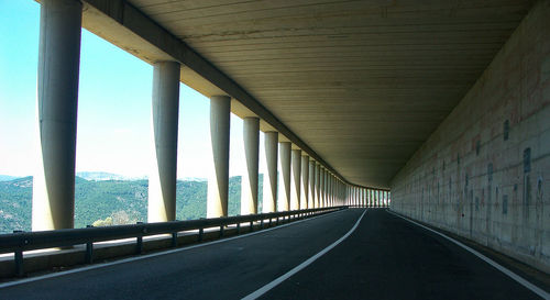 Empty road along bridge
