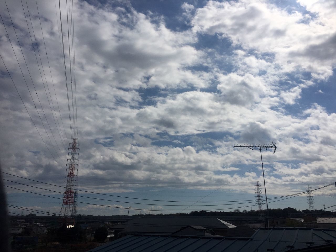 sky, power line, electricity pylon, cloud - sky, electricity, cable, built structure, connection, cloudy, building exterior, power supply, architecture, cloud, fuel and power generation, city, technology, low angle view, outdoors, street light, power cable