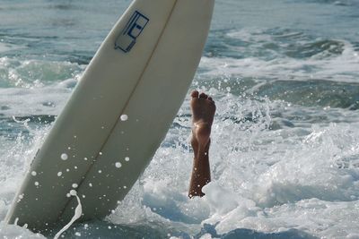 Low section of shirtless man in sea