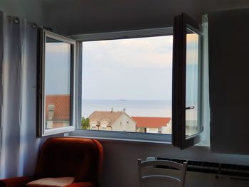 Scenic view of sea seen through window