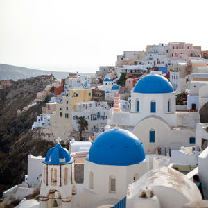 Buildings in city against clear sky