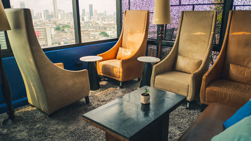 Empty chairs and tables in building