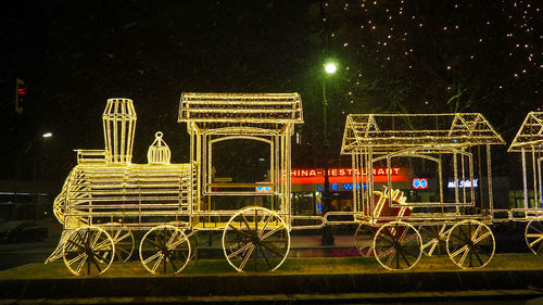 Bicycles parked against illuminated street light at night