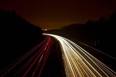 Streaks of lights of moving vehicles on road at night