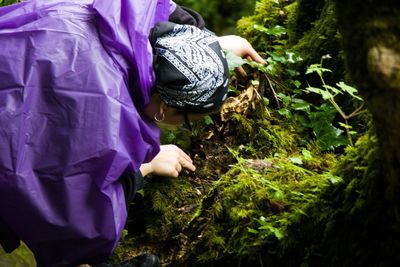 Midsection of woman working on purple land