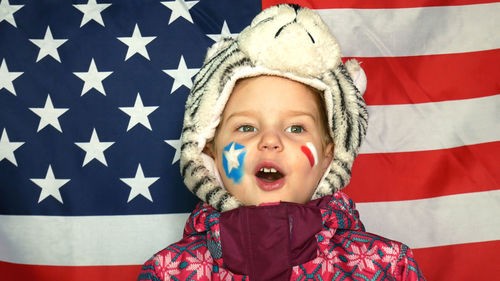 Cute girl in costume against american flag