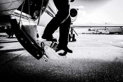 Low section of man on airplane staircase